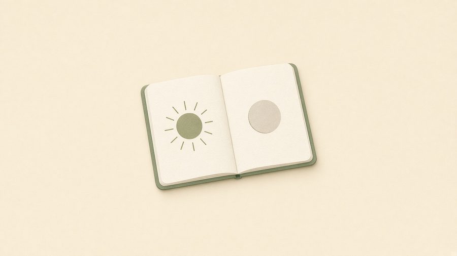 An open notebook with a sun on one page and a moon on the other.